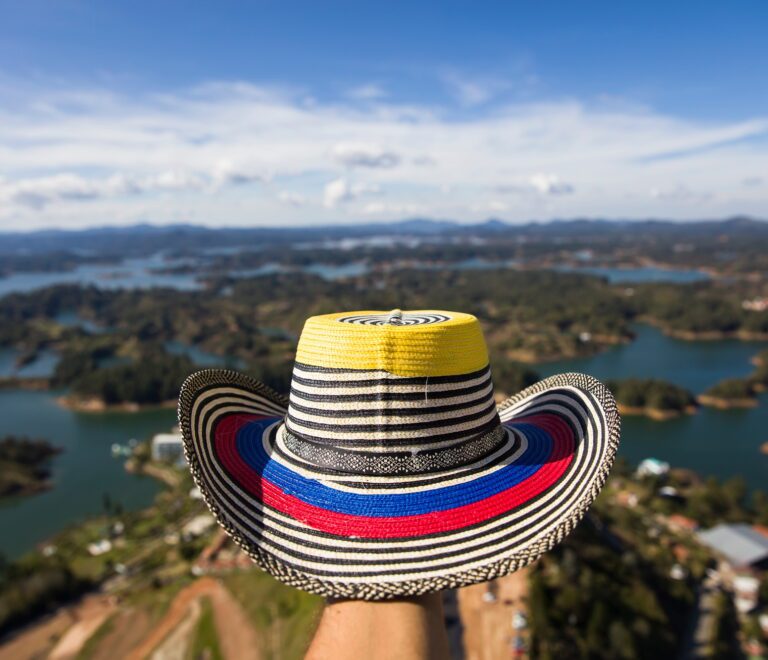 Hand with Colombian hat over Guatape lake in Antioquia, Colombia